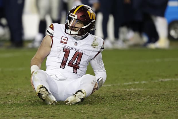 Washington Commanders quarterback Sam Howell (14) sits on the field after throwing an interception