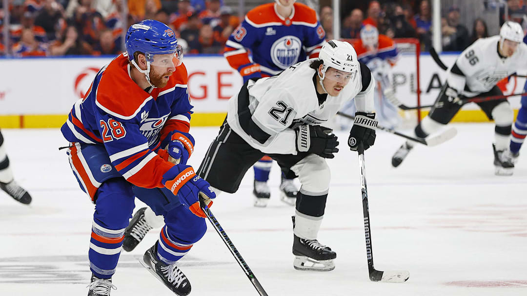 May 1, 2025; Edmonton, Alberta, CAN; Edmonton Oilers forward Connor Brown (28) looks to make a pass in front of Los Angeles Kings defensemen Jordan Spence (21) during the second period in game six of the first round of the 2025 Stanley Cup Playoffs at Rogers Place. Mandatory Credit: Perry Nelson-Imagn Images