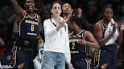 Jul 22, 2025; Brooklyn, New York, USA;  Indiana Fever guard Caitlin Clark (not in uniform) celebrates from the bench in the first quarter against the New York Liberty at Barclays Center. Mandatory Credit: Wendell Cruz-Imagn Images