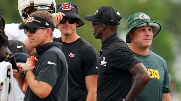 Aug 9, 2023; Cincinnati, OH, USA; Cincinnati Bengals quarterback Joe Burrow (9), center, talks with former Cincinnati Bengals wide receiver Chad Johnson during a joint practice between the Green Bay Packers and the Cincinnati Bengals, Wednesday, Aug. 9, 2023, at the practice fields next to Paycor Stadium in Cincinnati. Mandatory Credit: Kareem Elgazzar-USA TODAY Sports 