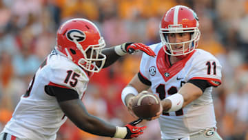 Oct 5, 2013; Knoxville, TN, USA; Georgia Bulldogs quarterback Aaron Murray (11) hands the ball off to running back J.J. Green (15) during the second half at Neyland Stadium. Georgia won in overtime 34 to 31. Mandatory Credit: Randy Sartin-Imagn Images