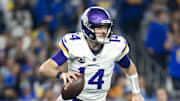 Jan 13, 2025; Glendale, AZ, USA; Minnesota Vikings quarterback Sam Darnold (14) against the Los Angeles Rams during an NFC wild card game at State Farm Stadium. Mandatory Credit: Mark J. Rebilas-Imagn Images