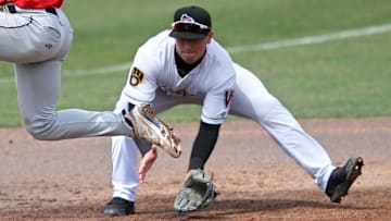 Cedar Rapids Kernels' Luke Keaschall (44) hurdles the ball as Wisconsin Timber Rattlers' Mike Boeve (19) fields it during their baseball game Wednesday, April 17, 2024, at Neuroscience Group Field at Fox Cities Stadium in Grand Chute, Wisconsin.