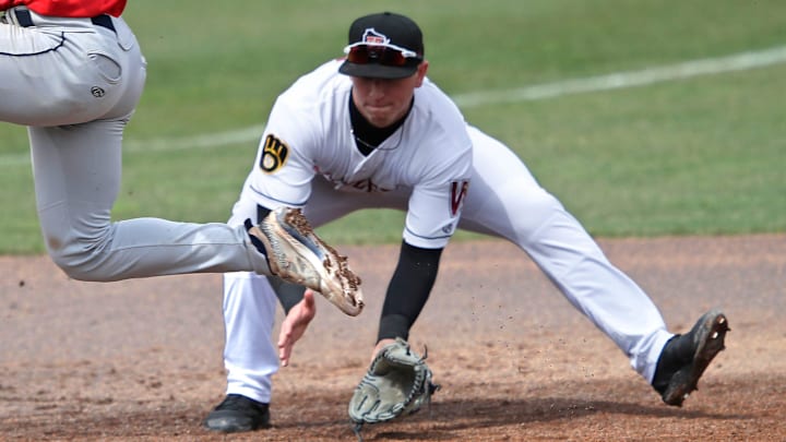 Cedar Rapids Kernels' Luke Keaschall (44) hurdles the ball as Wisconsin Timber Rattlers' Mike Boeve (19) fields it during their baseball game Wednesday, April 17, 2024, at Neuroscience Group Field at Fox Cities Stadium in Grand Chute, Wisconsin.