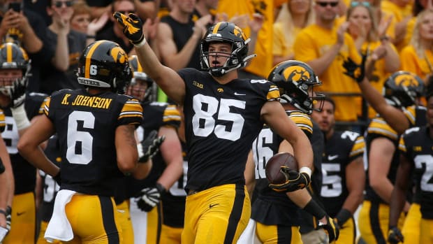 Iowa Hawkeyes tight end Luke Lachey celebrates a touchdown during a college football game in the Big Ten.