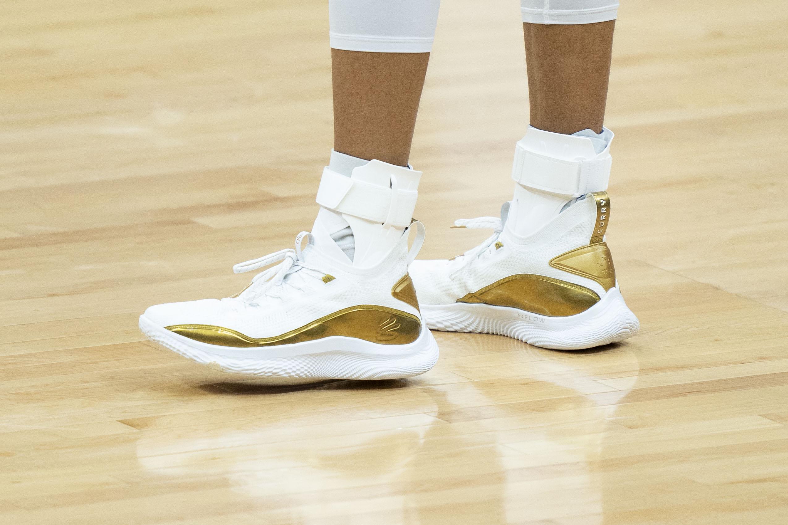 Stephen Curry's white and gold Under Armour sneakers.