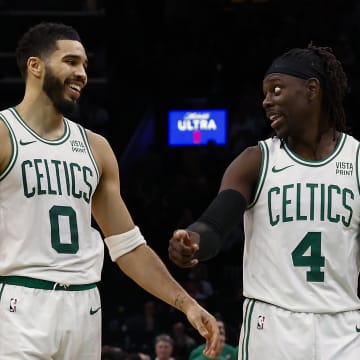 Jan 10, 2024; Boston, Massachusetts, USA; Boston Celtics forward Jayson Tatum (0) has a laugh with guard Jrue Holiday (4) during overtime of their 127-120 win over the Minnesota Timberwolves at TD Garden. Mandatory Credit: Winslow Townson-USA TODAY Sports