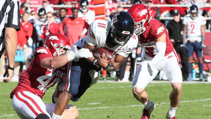 Nov 5, 2022; Fayetteville, Arkansas, USA; Arkansas Razorbacks defensive lineman Landon Jackson (40) and defensive back Hudson Clark (17) tackle Liberty Flames quarterback Johnathan Bennett (11) during the first quarter at Donald W. Reynolds Razorback Stadium. Mandatory Credit: Nelson Chenault-USA TODAY Sports