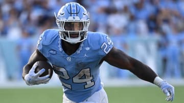 Sep 16, 2023; Chapel Hill, North Carolina, USA; DUPLICATE***North Carolina Tar Heels running back British Brooks (24)***North Carolina Tar Heels linebacker Malaki Hamrick (24) with the ball as Minnesota Golden Gophers linebacker Maverick Baranowski (6) defends in the fourth quarter at Kenan Memorial Stadium. Mandatory Credit: Bob Donnan-USA TODAY Sports