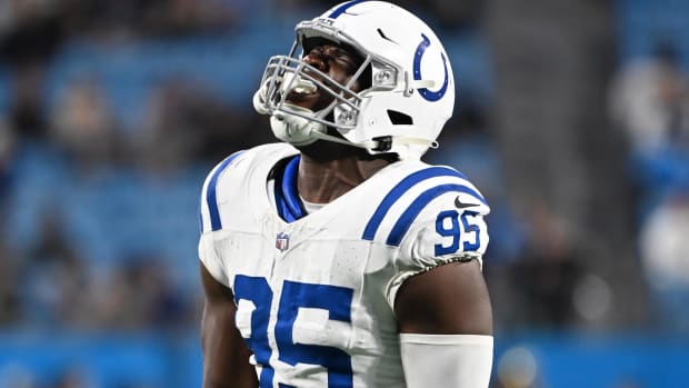 Colts defender Adetomiwa Adebawore (white uniform/helmet with blue trim) celebrates after a big play. 