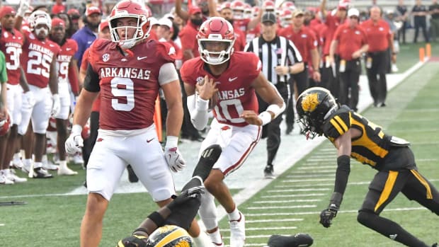 Razorbacks quarterback Taylen Green runs into traffic behind tight end Luke Hasz near the goal.