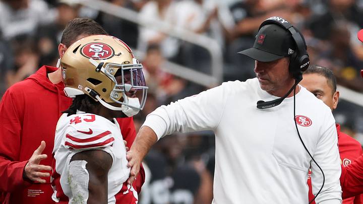 San Francisco 49ers running back Corey Kiner (L) and head coach Kyle Shanahan (R)