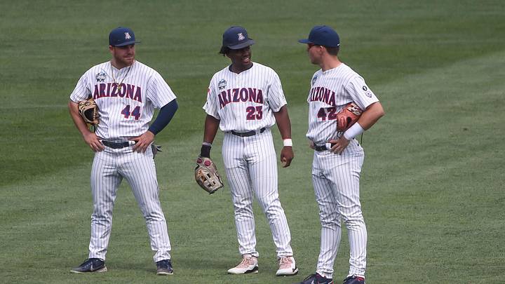 Jun 21, 2021; Omaha, Nebraska, USA;  Arizona Wildcats outfielder Tanner O'Tremba (44) and outfielder Donta Williams (23) and outfielder Ryan Holgate (42) during a break in the seventh inning against the Stanford Cardinal at TD Ameritrade Park. Mandatory Credit: Steven Branscombe-Imagn Images