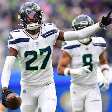 Dec 4, 2022; Inglewood, California, USA; Seattle Seahawks cornerback Tariq Woolen (27) celebrates after intercepting a pass intended for Los Angeles Rams running back Kyren Williams (23) during the first half at SoFi Stadium. 