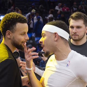 Dec 28, 2019; San Francisco, California, USA; Golden State Warriors guard Stephen Curry, left, exchanges pleasantries with his brother Dallas Mavericks guards Seth Curry and Luka Doncic following their NBA basketball game at Chase Center. Mandatory Credit: D. Ross Cameron-Imagn Images