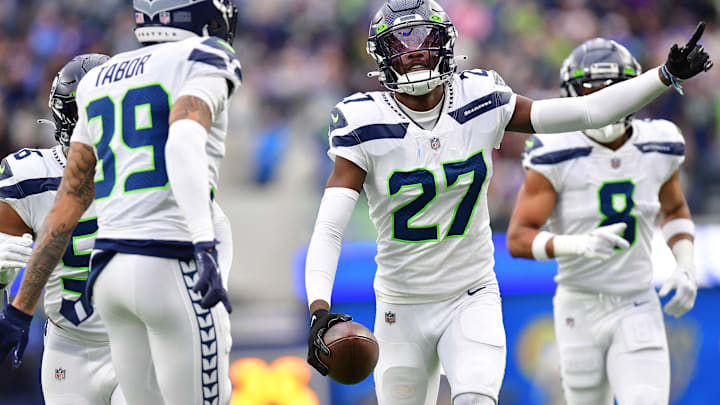 Dec 4, 2022; Inglewood, California, USA; Seattle Seahawks cornerback Tariq Woolen (27) celebrates after intercepting a pass intended for Los Angeles Rams running back Kyren Williams (23) during the first half at SoFi Stadium. 