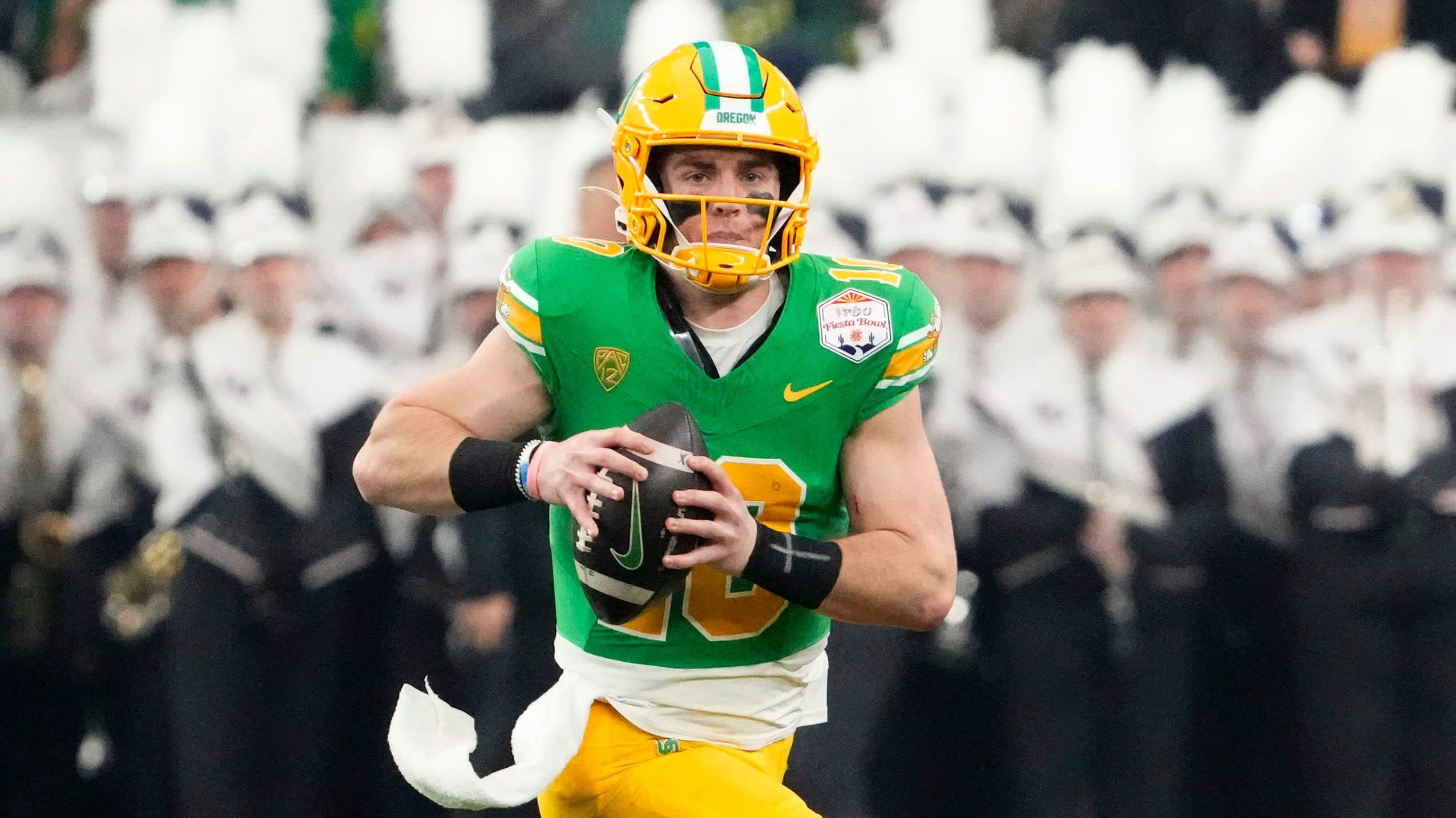 Oregon Ducks quarterback Bo Nix attempts a pass during a college football game.