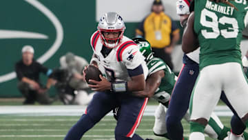 Sep 19, 2024; East Rutherford, New Jersey, USA;  New York Jets linebacker Quincy Williams (56)  sacks New England Patriots quarterback Jacoby Brissett (7) in the 1st half at MetLife Stadium. Mandatory Credit: Robert Deutsch-Imagn Images