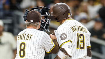 Jun 9, 2025; San Diego, California, USA; San Diego Padres manager Mike Shildt (8) gets in between home plate umpire Mike Estabrook and San Diego Padres third baseman Manny Machado (13) during the tenth inning against the Los Angeles Dodgers at Petco Park. Mandatory Credit: David Frerker-Imagn Images