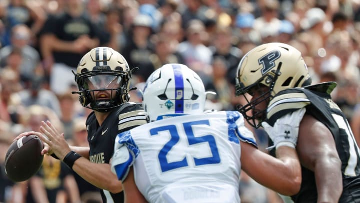 Purdue Boilermakers quarterback Hudson Card (1) throws the ball 