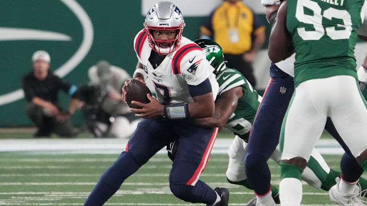 Sep 19, 2024; East Rutherford, New Jersey, USA; New York Jets linebacker Quincy Williams (56) sacks New England Patriots quarterback Jacoby Brissett (7) in the 1st half at MetLife Stadium. Sep 19, 2024; East Rutherford, New Jersey, USA; New York Jets linebacker Quincy Williams (56) sacks New England Patriots quarterback Jacoby Brissett (7) in the 1st half at MetLife Stadium.