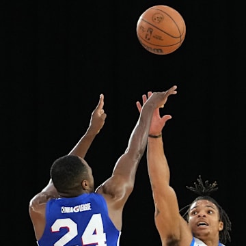 Dec 22, 2021; Las Vegas, NV, USA; Oklahoma City Blue guard Rob Edwards (25) defends against a shot by Delaware Blue Coats guard Jared Brownridge (24) during the second quarter at Mandalay Bay Convention Center. Mandatory Credit: Stephen R. Sylvanie-Imagn Images