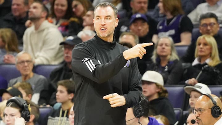 Jan 31, 2026; Evanston, Illinois, USA; Washington Huskies head coach Danny Sprinkle gestures to his name against the Northwestern Wildcats during the first half at Welsh-Ryan Arena. Mandatory Credit: David Banks-Imagn Images