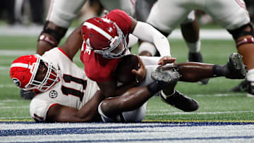 Alabama quarterback Jalen Milroe (4) is taken down by Georgia linebacker Jalon Walker (11) during the second half of the SEC Championship game at Mercedes-Benz Stadium in Atlanta, on Saturday, Dec. 2, 2023. Alabama won 27-24.