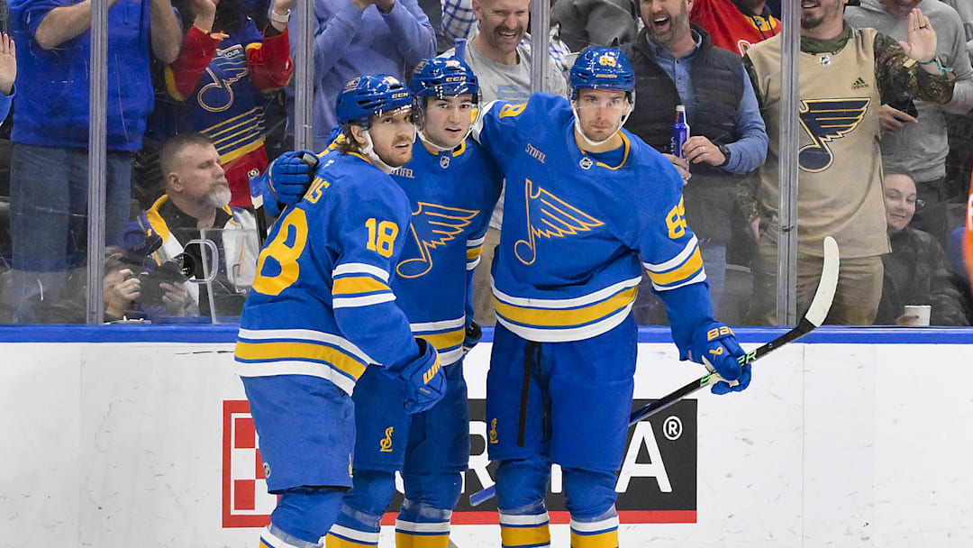 Nov 14, 2025; St. Louis, Missouri, USA; St. Louis Blues right wing Jimmy Snuggerud (21) is congratulated by center Robert Thomas (18) and left wing Pavel Buchnevich (89) after scoring against the Philadelphia Flyers during the first period at Enterprise Center. Mandatory Credit: Jeff Curry-Imagn Images