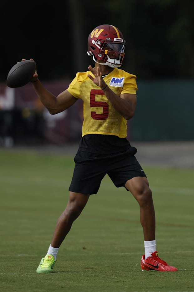 Washington Commanders quarterback Jayden Daniels passes a ball during practice on day one of training camp