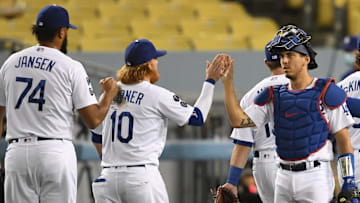 Los Angeles Dodgers relief pitcher Kenley Jansen (74),  third baseman Justin Turner (10) and catcher Austin Barnes (15) high five after defeating the Colorado Rockies in the ninth inning at Dodger Stadium in 2021.
