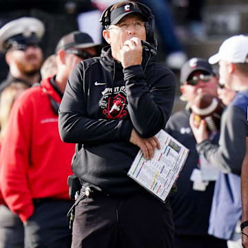 Cincinnati Bearcats head coach Scott Satterfield, left, watches an instant replay video on the jumbo screen in the fourth quarter of a college football game between the Cincinnati Bearcats and West Virginia Mountaineers, Saturday, Nov. 9, 2024, at Nippert Stadium in Cincinnati. Mountaineers won 31-24.