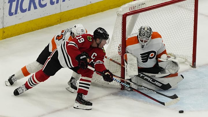 Apr 13, 2023; Chicago, Illinois, USA; Philadelphia Flyers goaltender Felix Sandstrom (32) makes a save on Chicago Blackhawks center Jonathan Toews (19) during the first period at United Center. 