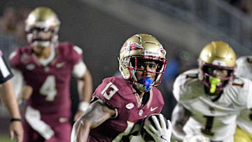 Sep 2, 2024; Tallahassee, Florida, USA; Florida State Seminoles running back Jaylin Lucas (13) runs the ball during the first half against the Boston College Eagles at Doak S. Campbell Stadium. Mandatory Credit: Melina Myers-Imagn Images