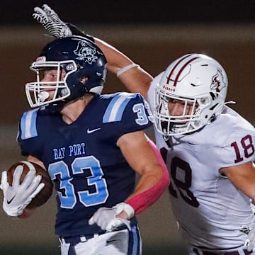 Bay Port High School's Brady Moon (33) breaks a tackle by De Pere High School's Cayden Cavanaugh (18) on his way to scoring a touchdown on Friday, October 3, 2025, at Bay Port High School in Suamico, Wis. Bay Port won the game, 56-7.
Tork Mason/USA TODAY NETWORK-Wisconsin