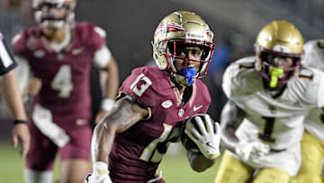 Sep 2, 2024; Tallahassee, Florida, USA; Florida State Seminoles running back Jaylin Lucas (13) runs the ball during the first half against the Boston College Eagles at Doak S. Campbell Stadium. Mandatory Credit: Melina Myers-Imagn Images