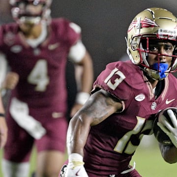 Sep 2, 2024; Tallahassee, Florida, USA; Florida State Seminoles running back Jaylin Lucas (13) runs the ball during the first half against the Boston College Eagles at Doak S. Campbell Stadium. Mandatory Credit: Melina Myers-Imagn Images