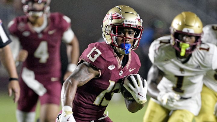 Sep 2, 2024; Tallahassee, Florida, USA; Florida State Seminoles running back Jaylin Lucas (13) runs the ball during the first half against the Boston College Eagles at Doak S. Campbell Stadium. Mandatory Credit: Melina Myers-Imagn Images