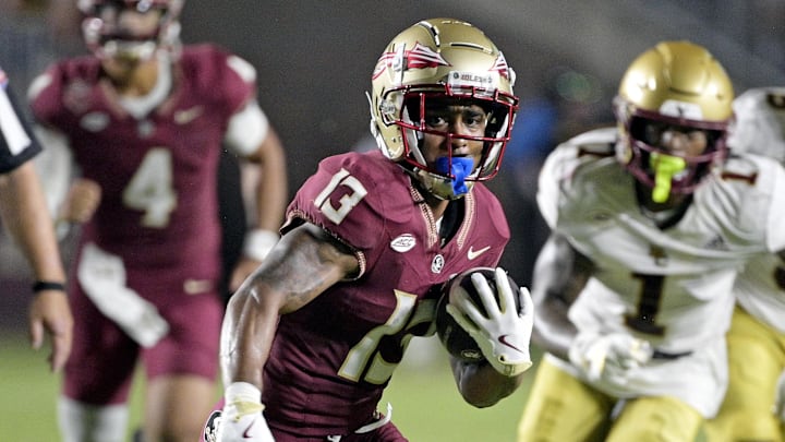 Sep 2, 2024; Tallahassee, Florida, USA; Florida State Seminoles running back Jaylin Lucas (13) runs the ball during the first half against the Boston College Eagles at Doak S. Campbell Stadium. Mandatory Credit: Melina Myers-Imagn Images