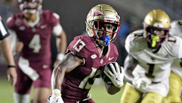 Sep 2, 2024; Tallahassee, Florida, USA; Florida State Seminoles running back Jaylin Lucas (13) runs the ball during the first half against the Boston College Eagles at Doak S. Campbell Stadium. Mandatory Credit: Melina Myers-Imagn Images