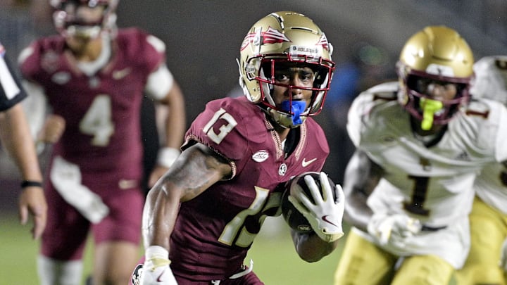 Sep 2, 2024; Tallahassee, Florida, USA; Florida State Seminoles running back Jaylin Lucas (13) runs the ball during the first half against the Boston College Eagles at Doak S. Campbell Stadium. Mandatory Credit: Melina Myers-Imagn Images