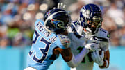 Tennessee Titans safety Kevin Winston Jr. (23) tries to stop Seattle Seahawks wide receiver Jaxon Smith-Njigba (11) during the second quarter at Nissan Stadium in Nashville, Tenn., Sunday, Nov. 23, 2025.