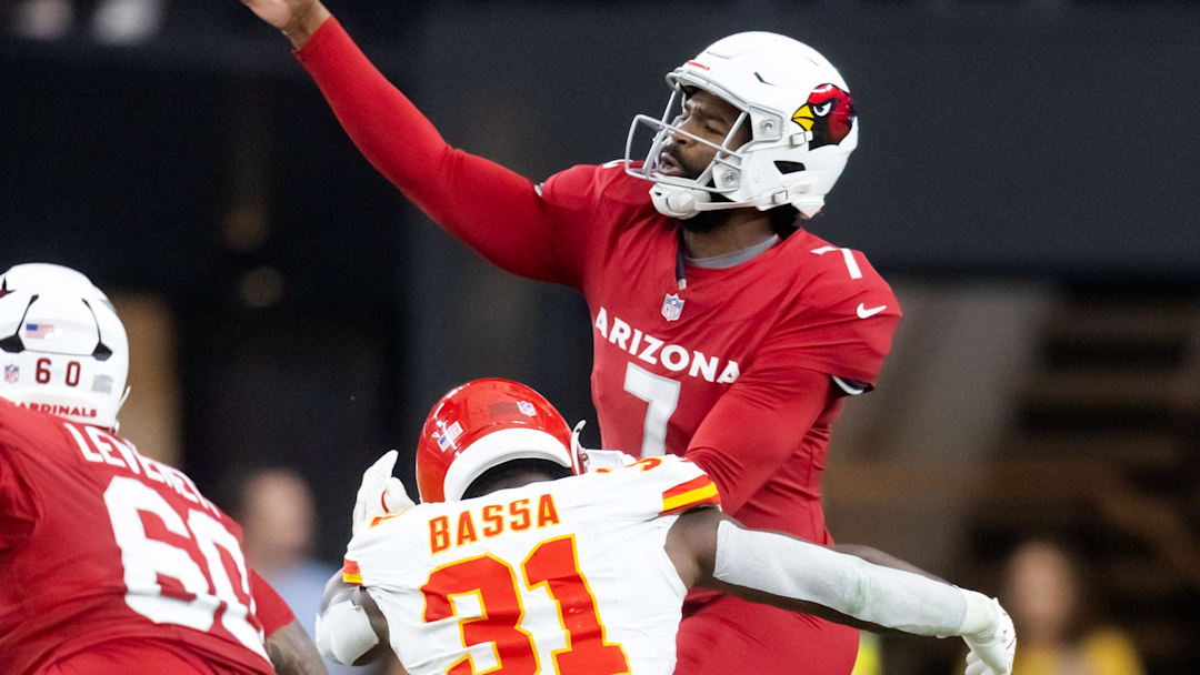 Aug 9, 2025; Glendale, Arizona, USA; Arizona Cardinals quarterback Jacoby Brissett (7) under pressure from Kansas City Chiefs linebacker Jeffrey Bassa (31) during a preseason NFL game at State Farm Stadium. Mandatory Credit: Mark J. Rebilas-Imagn Images