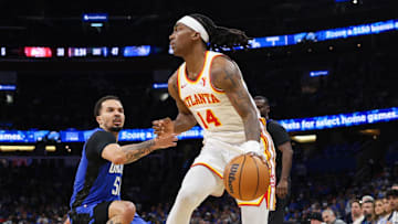 Apr 15, 2025; Orlando, Florida, USA; Atlanta Hawks guard Terance Mann (14) controls the ball against the Orlando Magic in the second quarter at Kia Center. Mandatory Credit: Nathan Ray Seebeck-Imagn Images
