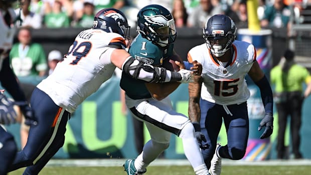 Philadelphia Eagles quarterback Jalen Hurts (1) is tackled by Denver Broncos defensive end Zach Allen (99).