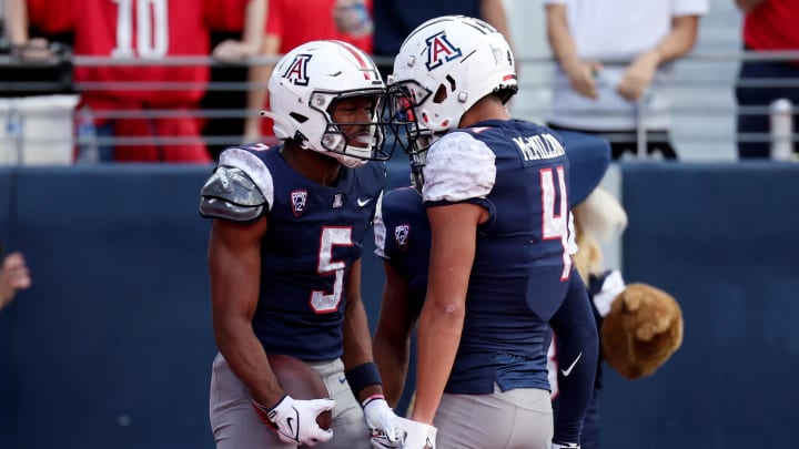 Nov 18, 2023; Tucson, Arizona, USA; Arizona Wildcats wide receiver Montana Lemonious-Craig (5) celebrates with wide receiver Tetairoa McMillan (4) after a touchdown against the Utah Utes during the first half at Arizona Stadium.