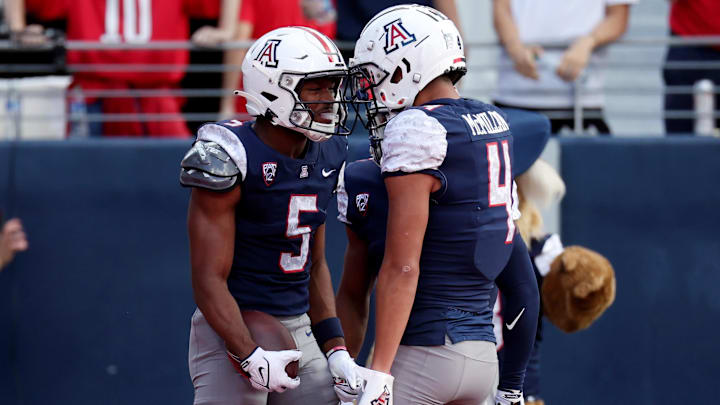 Nov 18, 2023; Tucson, Arizona, USA; Arizona Wildcats wide receiver Montana Lemonious-Craig (5) celebrates with wide receiver Tetairoa McMillan (4) after a touchdown against the Utah Utes during the first half at Arizona Stadium.