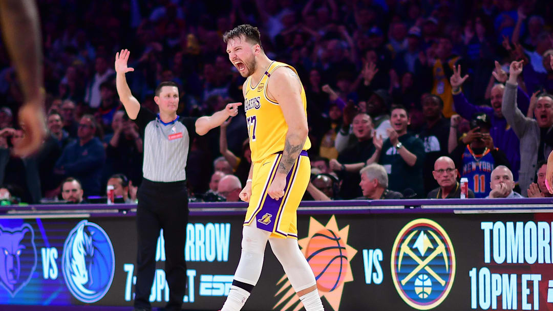 Mar 6, 2025; Los Angeles, California, USA; Los Angeles Lakers guard Luka Doncic (77) reacts after scoring a basket against the New York Knicks during overtime at Crypto.com Arena. Mandatory Credit: Gary A. Vasquez-Imagn Images