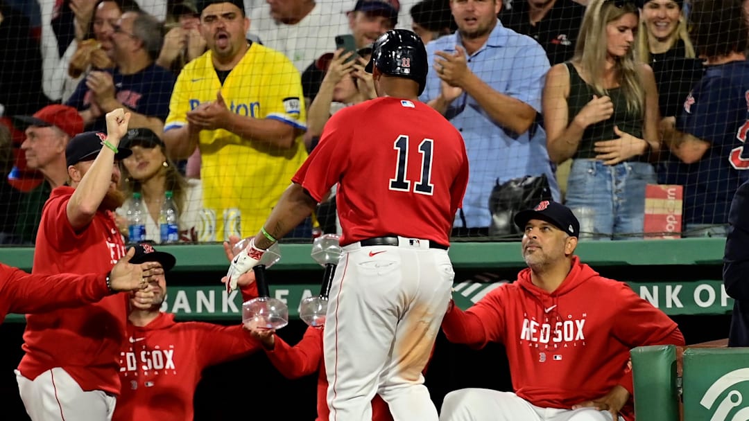 Sep 14, 2023; Boston, Massachusetts, USA; Boston Red Sox designated hitter Rafael Devers (11) celebrates his home run against the New York Yankees with manager Alex Cora (13) during the third inning at Fenway Park. Mandatory Credit: Eric Canha-Imagn Images