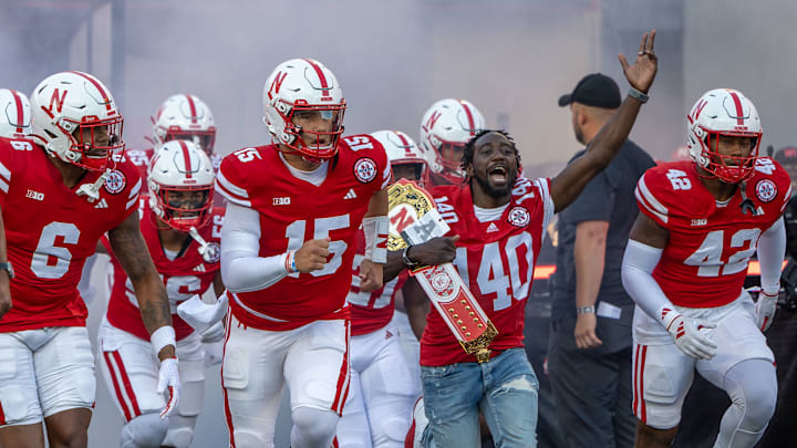 Joined by boxer Bud Crawford, Nebraska players come out of the tunnel before taking on Colorado.